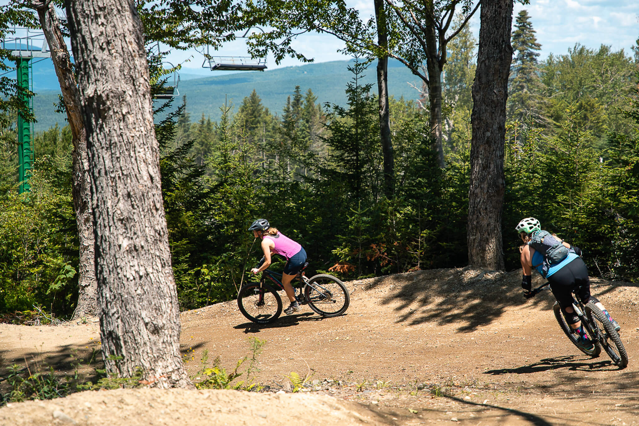 Bikers on Saddleback flow trail corner