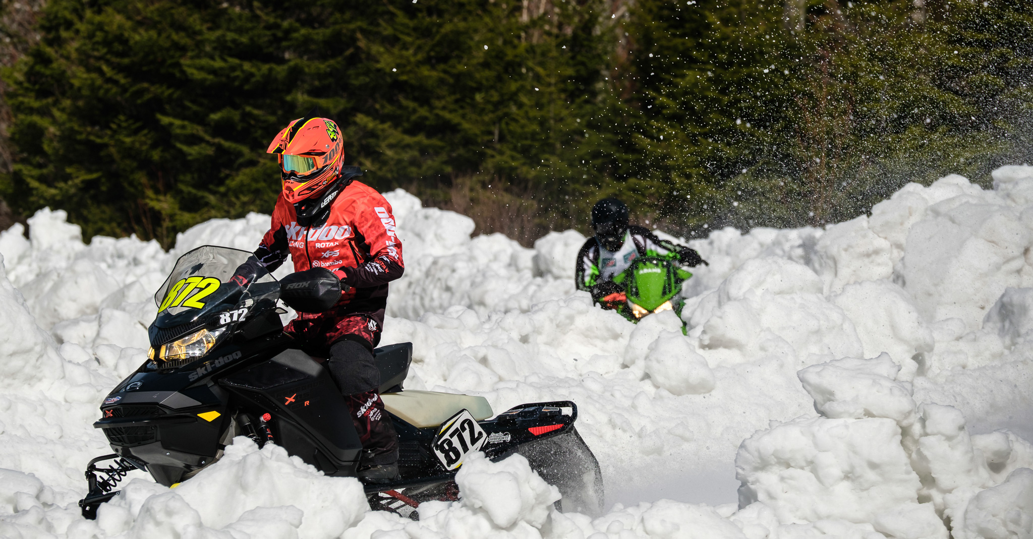 two snowmobiles racing King of the Mountain 2023