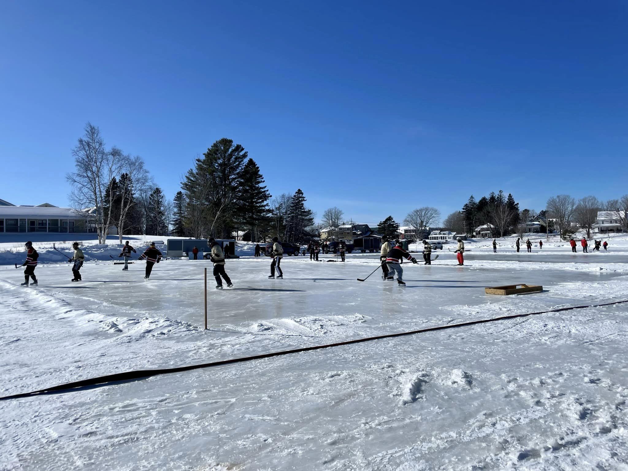 Pond hockey on Haley Pond blue sky day