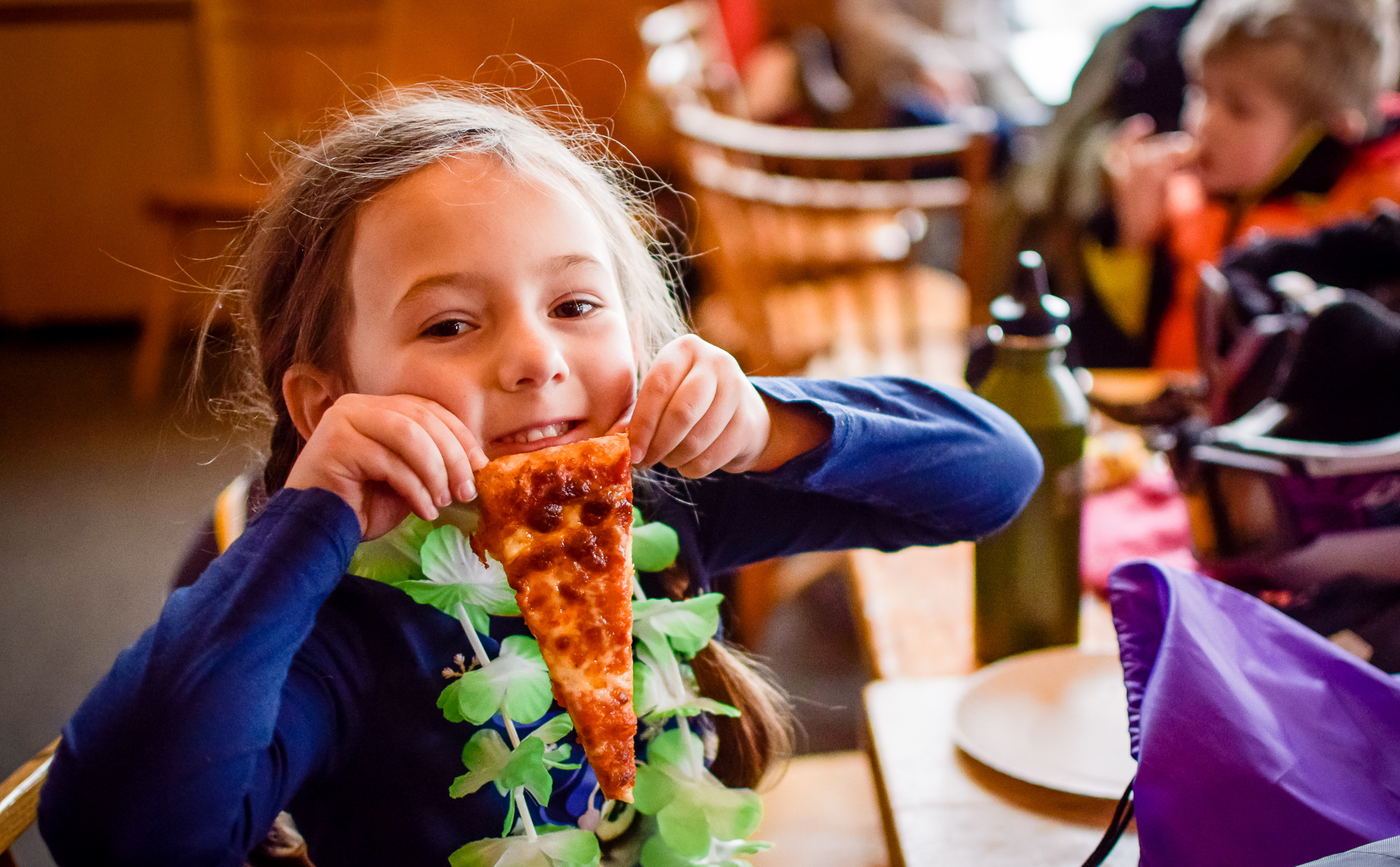 Smiling child with pizza slice