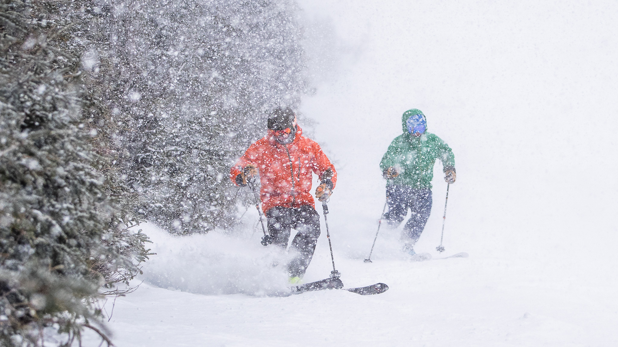 Two skiers snow falling