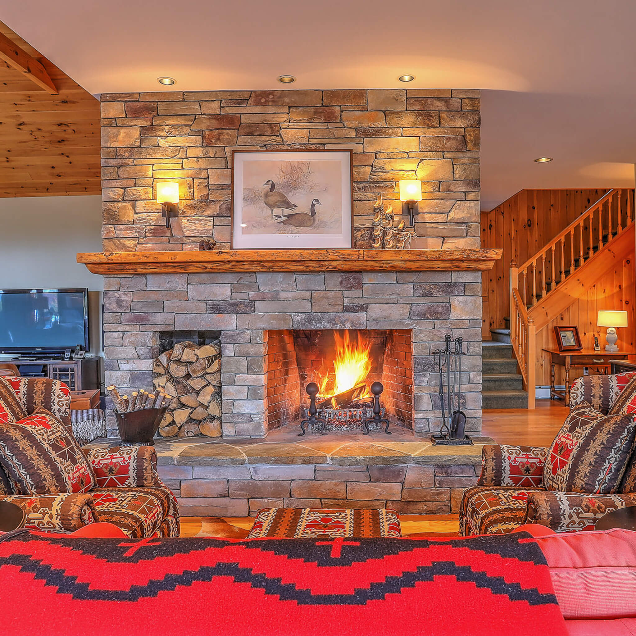 Living room with fireplace burning