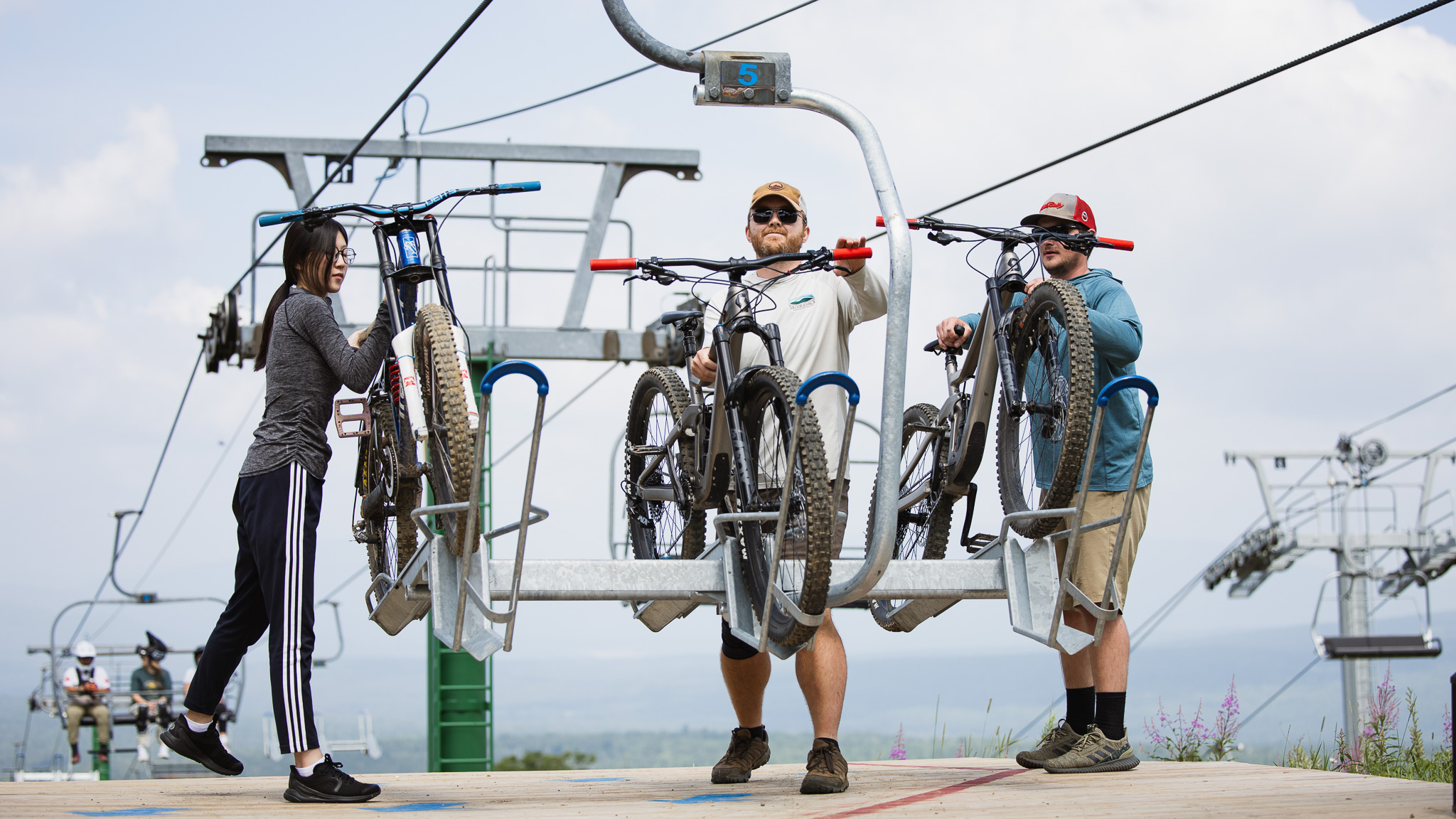 Bike park lift attendants unloading bikes